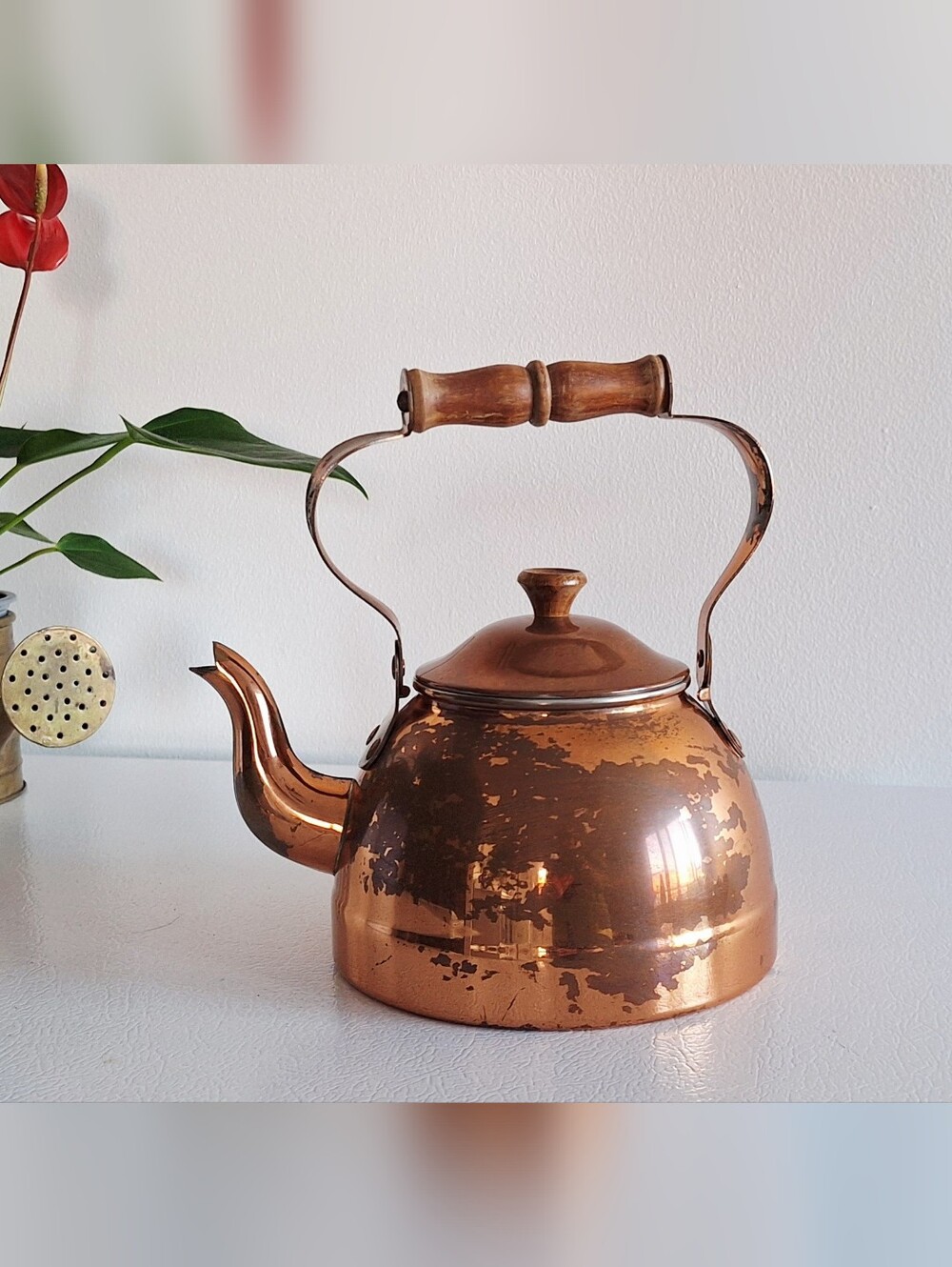 Copper kettle with wooden handle